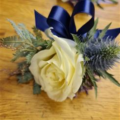 Fresh cream rose and thistle with mimosa greenary